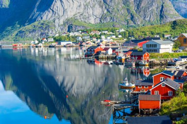Perfect reflection of the Reine village on the water of the fjord in the Lofoten Islands, Norway clipart