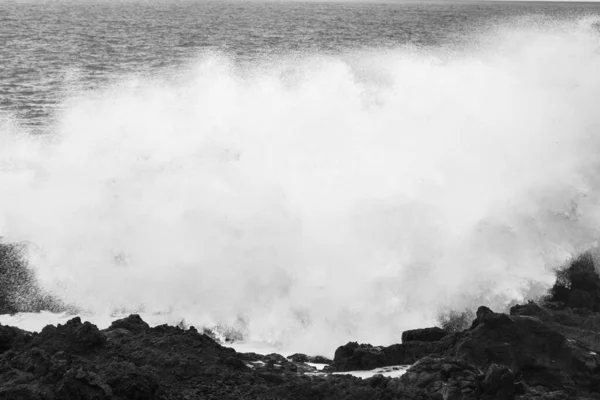 stock image Powerful waves of the Atlantic Ocean crashing on the volcanic cliffs of Los Hervideros in Lanzarote, Canary Islands, Spain, black and white