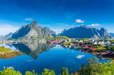 Perfect reflection of the Reine village on the water of the fjord in the Lofoten Islands, Norway