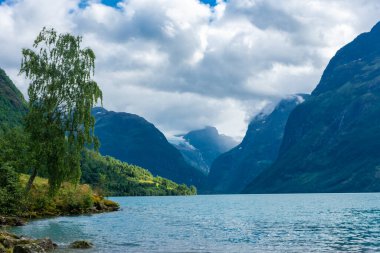 Landscape of the Lovatnet glacial lake with turquoise crystal clear water, Norway