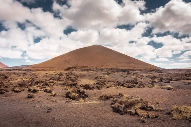 Wild volcanic landscape of Los Volcanes Natural Park in Lanzarote, Canary Islands, Spain