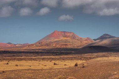 Wild volcanic landscape of Los Volcanes Natural Park in Lanzarote, Canary Islands, Spain
