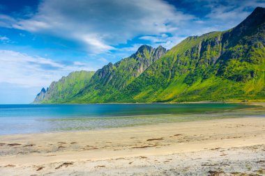 The crystal clear water of the Ersfjordstranda beach in Senja Island, Norway