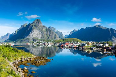 Perfect reflection of the Reine village on the water of the fjord in the Lofoten Islands, Norway