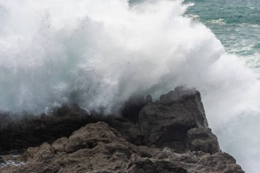 Powerful waves of the Atlantic Ocean crashing on the volcanic cliffs of Los Hervideros in Lanzarote, Canary Islands, Spain