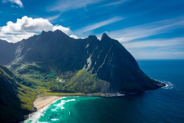 View over the turquoise water of Kvalvika Beach from Ryten Mount, Lofoten Islands, Norway