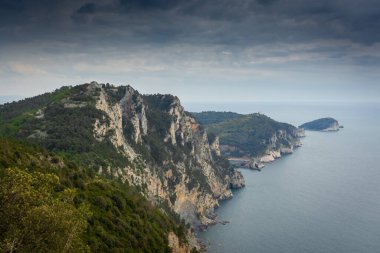 Hiking trail by the Ligurian sea with cloudy sky to Portovenere, Italy