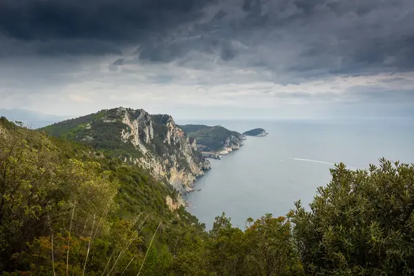 Hiking trail by the Ligurian sea with cloudy sky to Portovenere, Italy