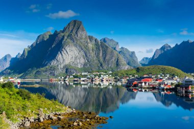 Perfect reflection of the Reine village on the water of the fjord in the Lofoten Islands, Norway