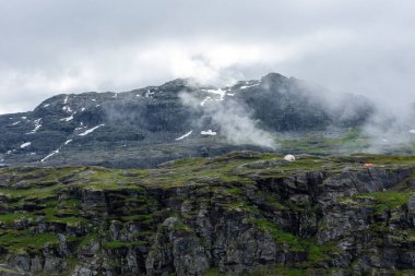 Moody foggy landscape in the mountains of Trolltunga, Norway