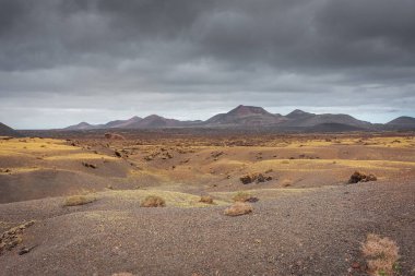 Wild volcanic landscape of Los Volcanes Natural Park in Lanzarote, Canary Islands, Spain