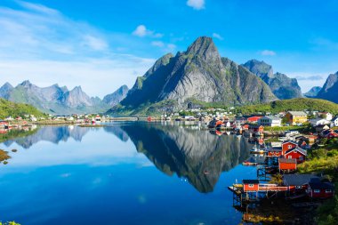 Perfect reflection of the Reine village on the water of the fjord in the Lofoten Islands, Norway