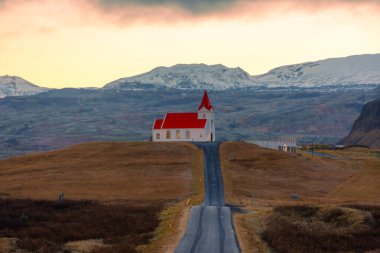 Perspective with Ingjaldsholskirkja Church at the end of the road, Iceland clipart