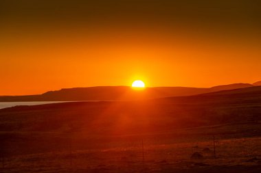 Spectacular sunrise over the wild and desolate lands of Iceland clipart