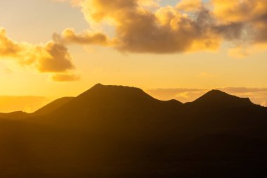 Beautiful silhouette of Lanzarote volcanos at sunset, Canary Islands, Spain