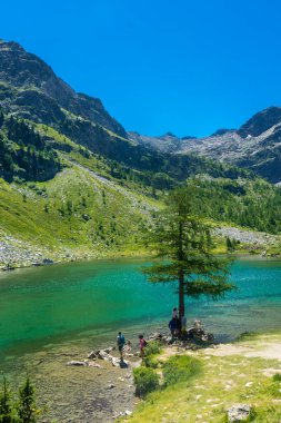 Morgex, Italy, 10 July 2022: The beautiful crystal clear water of the Arpy Lake in Aosta Valley clipart