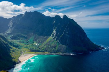 View over the turquoise water of Kvalvika Beach from Ryten Mount, Lofoten Islands, Norway