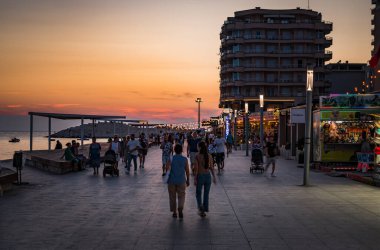 Durres, ALBANIA September 3 2022: waterfront promenade in Durres, port city in Albania with walking people and tourists. High quality photo clipart