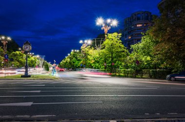 BUCHAREST, ROMANIA - 13 Eylül 2022: Büyük bir cadde olan Bulevardul Unirii 'de trafik ışıkları, saat ve arabalar. Yüksek kalite fotoğraf