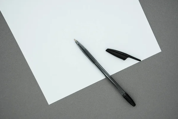 空白の白い紙と灰色の背景にペン テキストのためのスペースのコピー ワークスペースの上ビュー — ストック写真