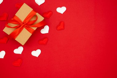 Valentine's Day background. Red and white hearts and box for St. Valentine's day gift. Concept of Valentine's, anniversary, mother's day and birthday greeting, copy space, top view.