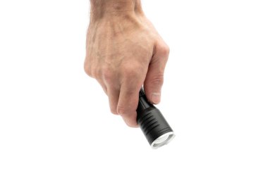 Male hand holding a black metal flashlight, isolated on white.
