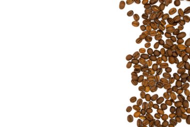 Brown coffee beans scattered on white with a lot copy space for text.