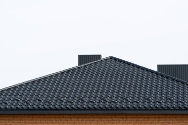 The roof of corrugated black sheet. Roof of a new home.