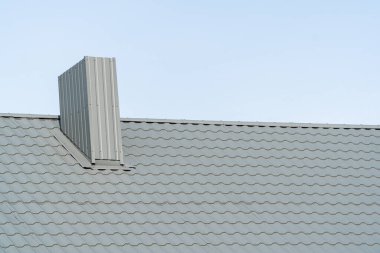 Gray metal roof tiles on the roof of the house.