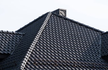 A tile roof on a new house. Modern roof made of metal. Modern house construction.