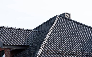Dark brown metal roof tiles. The roof of corrugated sheet. Roof of a new home.