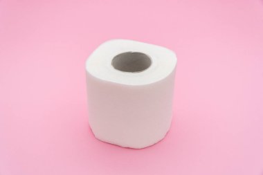 Toilet paper isolated on pink background.