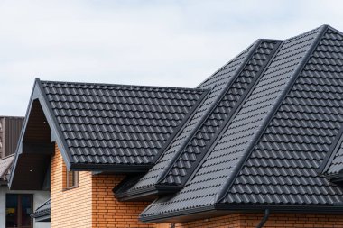 Roof covering with steel tiles. clipart