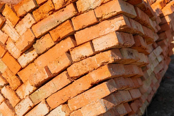 Red bricks for construction. Red brick is used in the construction of houses. Red brick on the construction site.