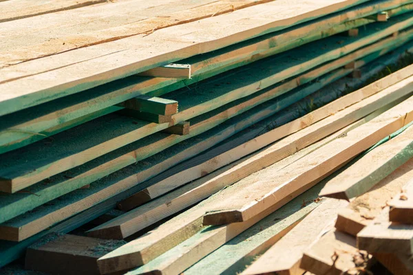 Wood timber in the sawmill. Piles of wooden boards in the sawmill. Wood, timber, wood blanks, construction material.