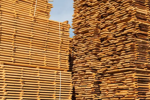 A boards in an industrial sawmill. Wood timber construction material. Heavy industry.