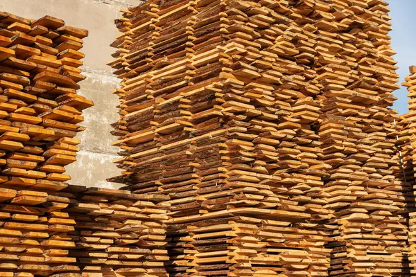 Fresh sawn timber. Sawmill. Production of wood material. Stacks of boards on a sawmill.