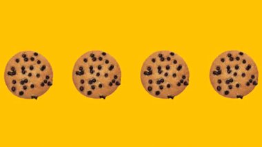 trendy food animation spinning cookies with chocolate drops on yellow background