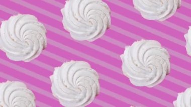 Rotating marshmallow on a pink striped background.Trendy food background in pop art style