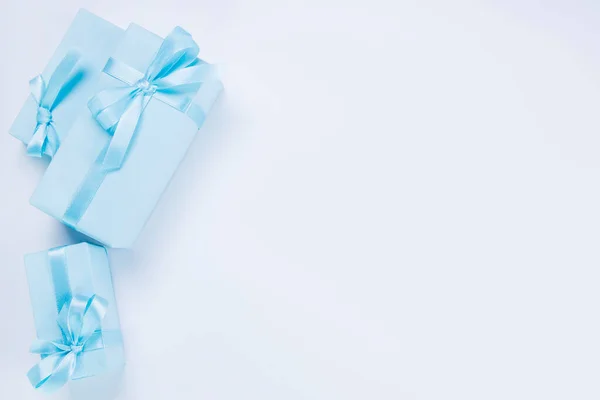 blue gift boxes with blue bows template for copy pasting, postcard, concept for celebrating a boy or man's birthday, party, anniversary or newborn. High quality photo