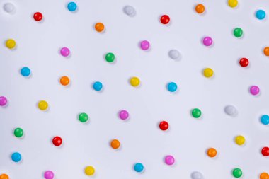  white background with multi-colored candies. Concept for celebrating a party, anniversary or birthday