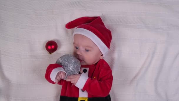 Month Old Baby Dressed Santa Claus Plays Christmas Toy Light — стокове відео