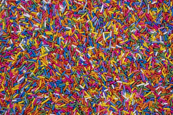 Tatlılar ve çok renkli cereyanlar için çok renkli serpintilerin arkaplanı. Doğum günü, parti ya da diğer bayramları kutlama konsepti. Moda, tatlı arka plan.