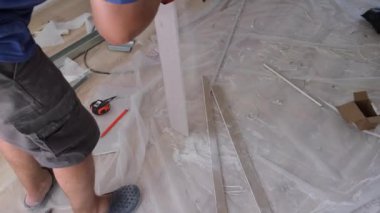 Profesyonel bir tamircinin elleri alçıdan yapılmış bir yaprağı bıçakla kesmiş. - konsept - onarım, inşaat malzemeleri, teknoloji. Yüksek kalite 4k görüntü