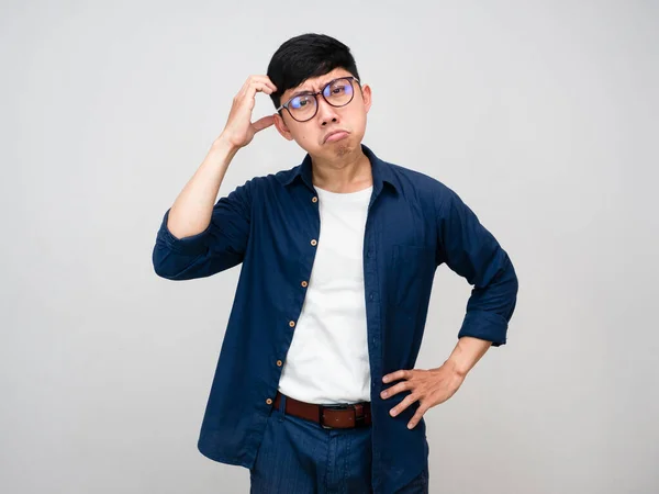 Stock image Asian man wear glasses scratch head feels doubt isolated