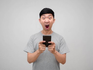 Gri gömlekli adam cep telefonunu kapalı tutarken şok oluyor.