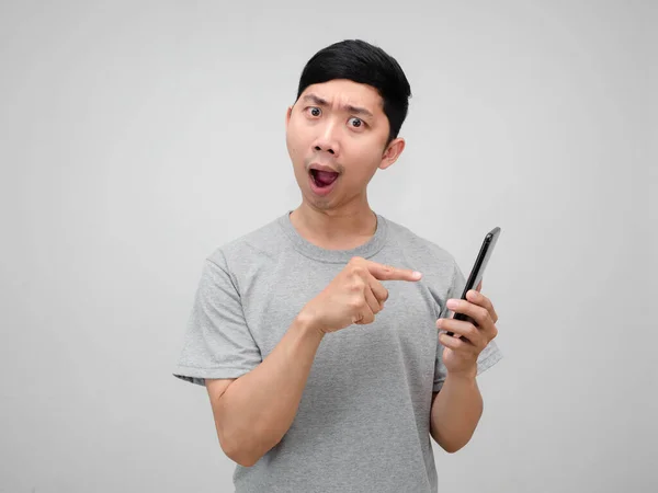Young Asian Man Hold Mobile Phone Feels Amazed Point Finger — Stock Photo, Image