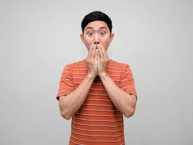 Asian man orange striped feels amazed gesture close his mouth isolated