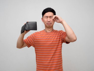 Poor man orange striped shirt holding wallet no money feels sad and cry isolated