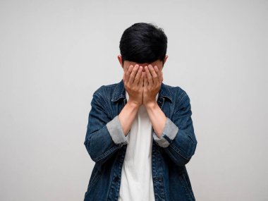 Sadness asian man jeans shirt feels disheartened,cry,headache isolated
